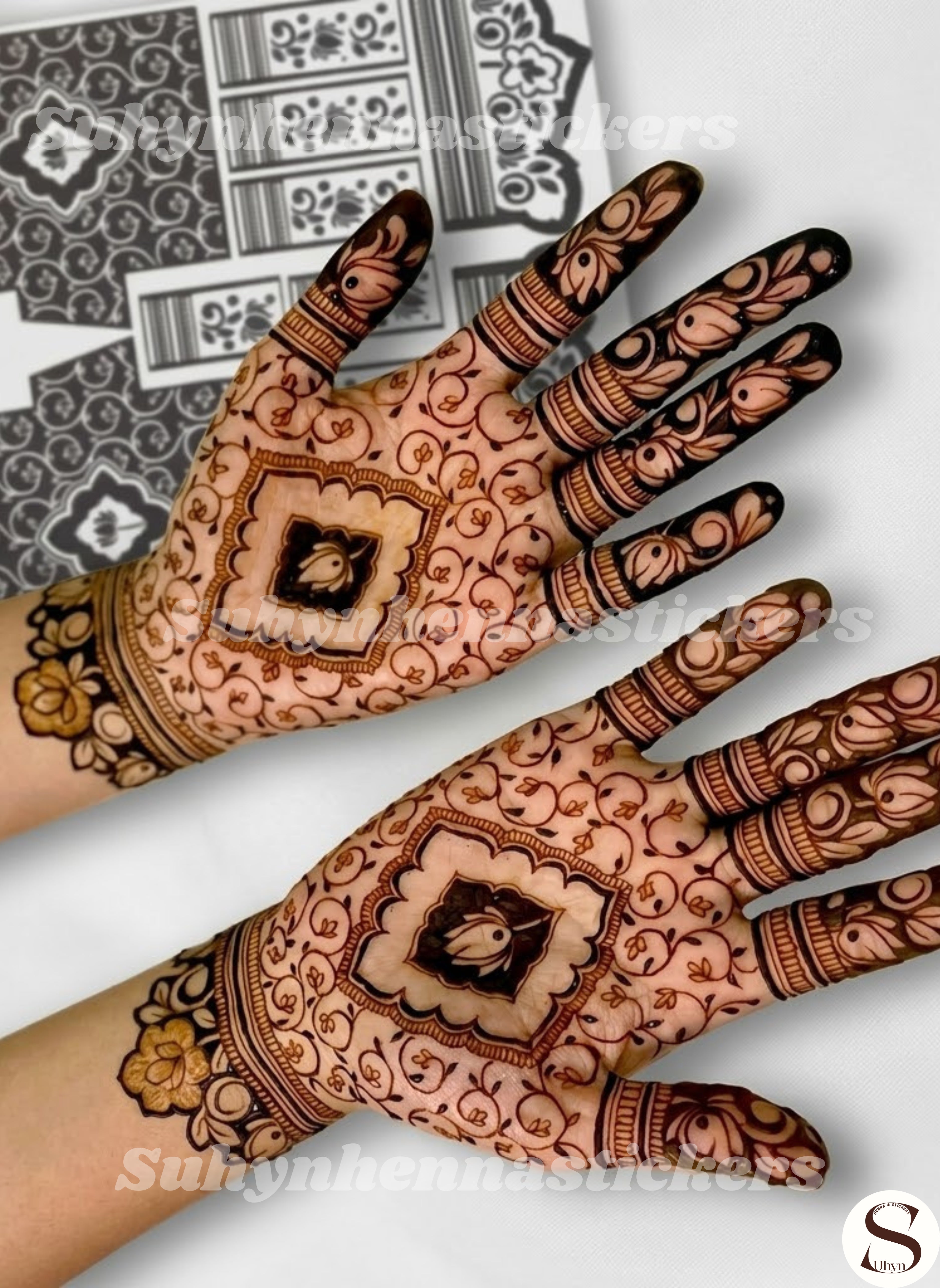 Botanical palm mehendi sticker featuring a framed floral centre, delicate vine fillers, bold petal fingertips and ornamental wrist flowers by Suhyn
