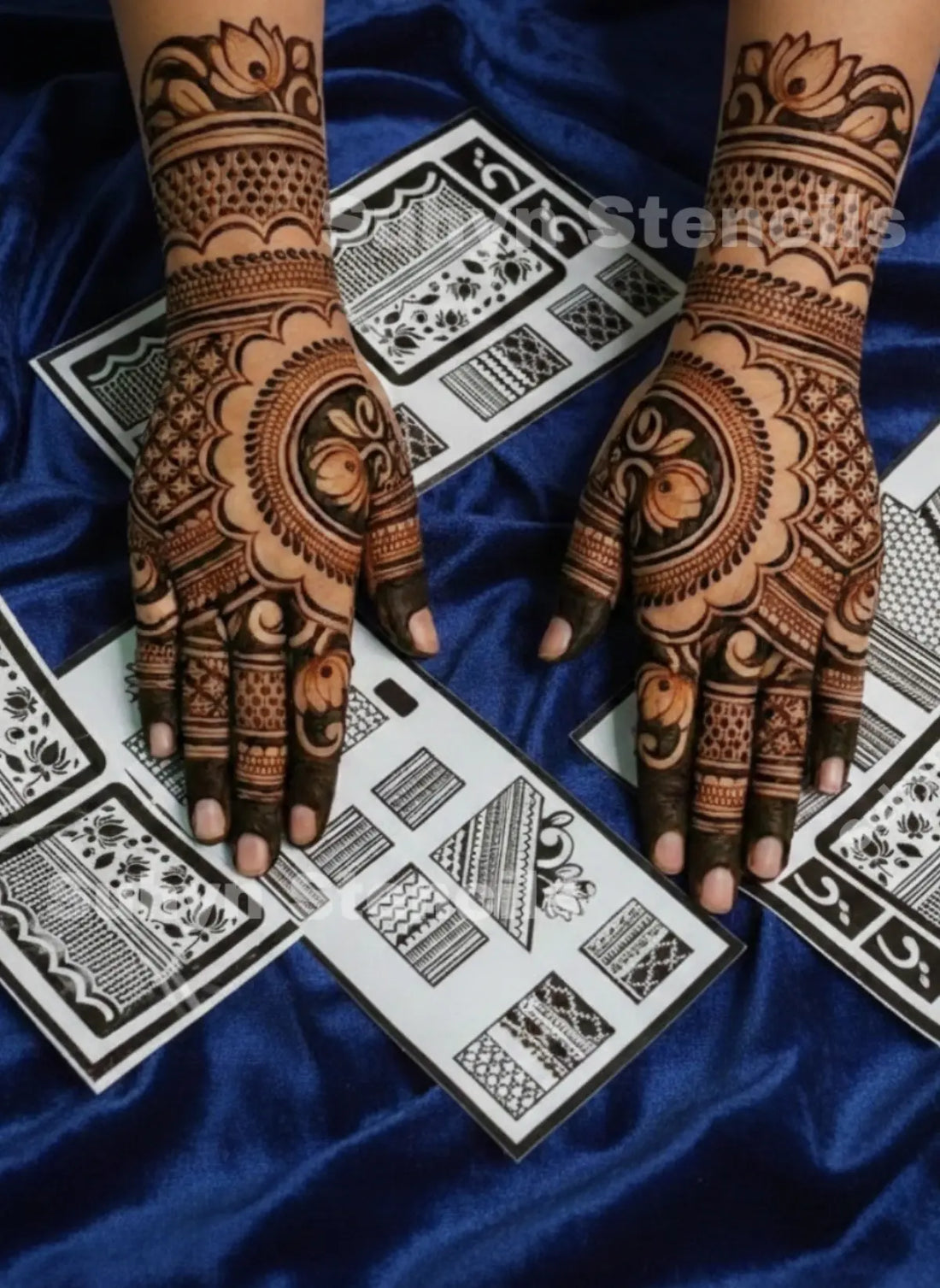 ALT TEXT
Semi-bridal lotus mehendi stencil with large floral palm arches, patterned fingers, net detailing and decorative wrist sections on both handS